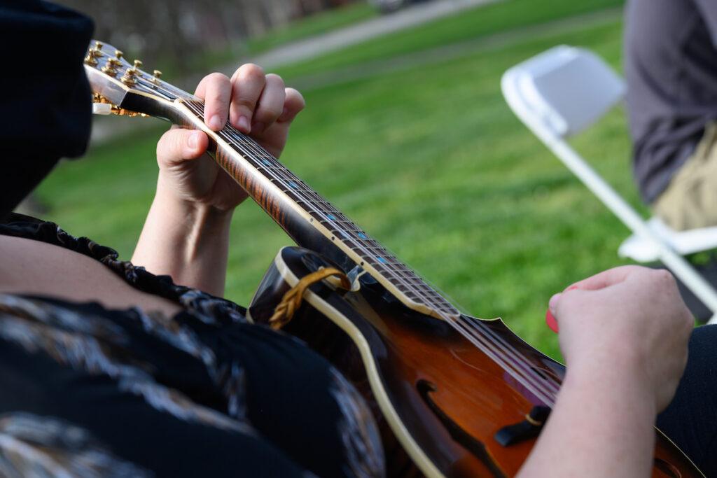 Close up of hands playing a guitar